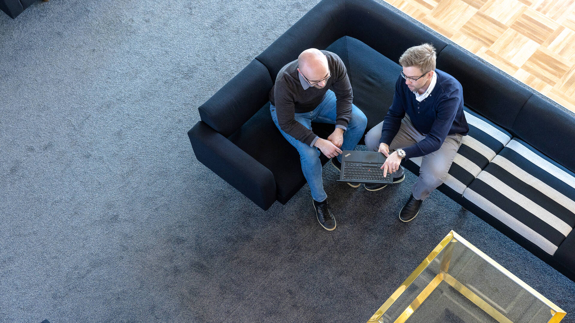 Two men looking at laptop